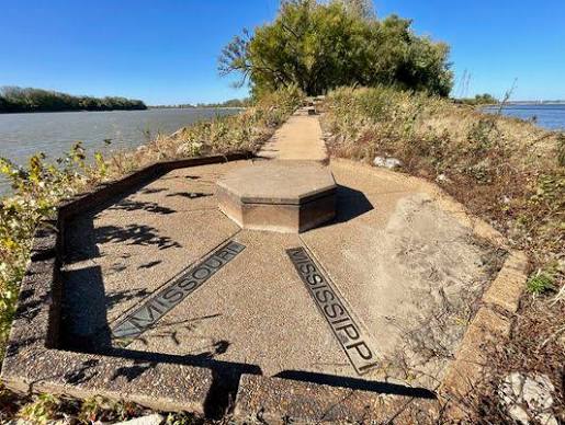 A stone plaza at the tip of the point with MISSOURI and MISSISSIPPI set into the pavement