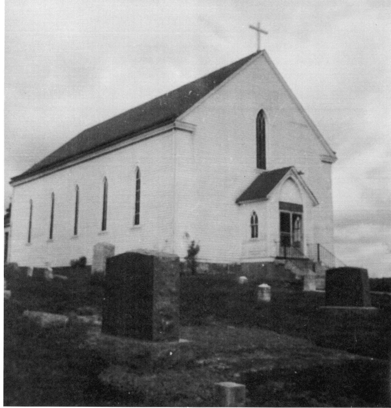 Saint Columbkille Church in Byrnesville, with its churchyard cemetery in the foreground