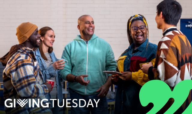 A group of people standing in a circle talking.